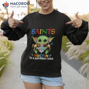 baby yoda hug new orleans saints autism rockin to a different tune shirt sweatshirt 1