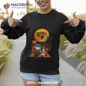 snoopy and charlie brown jacksonville jaguars sitting under moon halloween 2023 t shirt sweatshirt