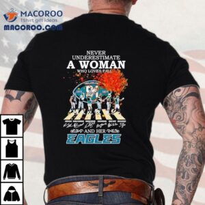 Never Underestimate A Woman Who Loves Fall And Her Philadelphia Eagles Walking Across Signatures Tshirt