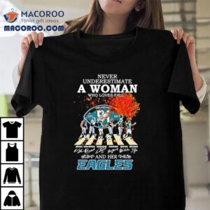 Never Underestimate A Woman Who Loves Fall And Her Philadelphia Eagles Walking Across Signatures Tshirt