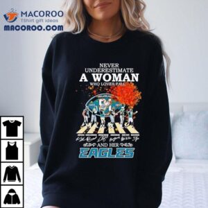 Never Underestimate A Woman Who Loves Fall And Her Philadelphia Eagles Walking Across Signatures Tshirt