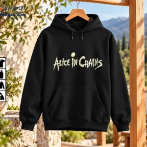 Alice In Chains shirt with a distressed cream band logo in jagged vintage lettering on black fabric