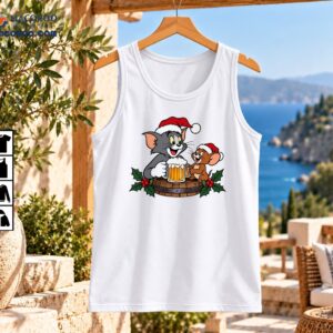 Christmas cartoon artwork featuring a gray cat and brown mouse in Santa hats sharing golden beer mugs on a holly-decorated wooden barrel