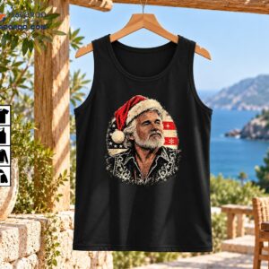 Vintage bearded country singer wearing a red Santa hat with distressed American flag and Western shirt artwork