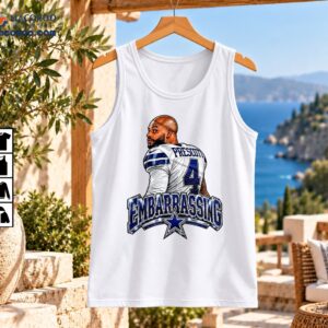 Embarrassing Prescott Number 4 Football Graphic Shirt 2 Football player wearing a white Prescott number 4 jersey above bold blue EMBARRASSING lettering and a star graphic