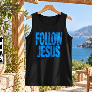 Follow Jesus shirt design with bold distressed blue lettering and a rugged vintage-inspired Christian graphic