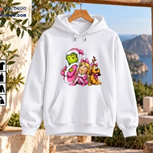 Green Christmas character in pink Santa outfit with a blonde girl in braids and a brown dog wearing pink bows and antlers