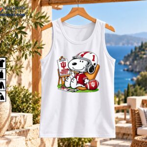 Snoopy in a crimson number 1 football uniform painting an Indiana Hoosiers sign beside a football and art supplies