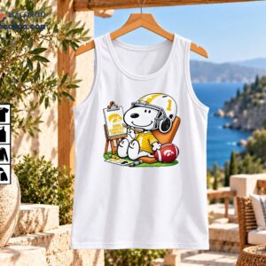 Snoopy in a gold number 1 football jersey and white helmet painting Iowa Hawkeyes Football beside a red football