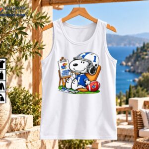 Snoopy in a blue number 1 football jersey and white helmet painting Kansas Jayhawks Football artwork beside a football