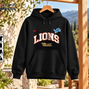 Lions ZZ Top The Big One Vintage Graphic Shirt 3 LIONS ZZ Top graphic with silver varsity lettering, orange-red outlines, blue leaping lion emblem, red swoosh, and gold logo