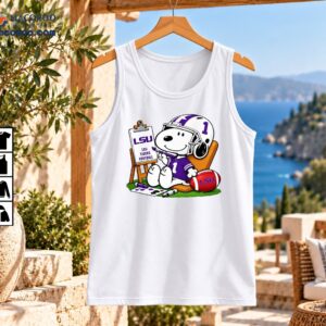 Cartoon dog painting LSU Tigers Football sign wearing purple number 1 jersey and helmet beside LSU football