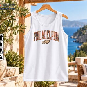 Philadelphia arched varsity wordmark with a distressed orange and brown camouflage pattern and eagle head graphic
