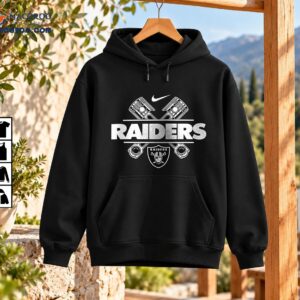 Raiders biker graphic with crossed engine pistons, bold RAIDERS lettering, swoosh and helmeted shield in distressed white