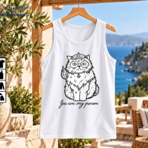 Fluffy cat wearing a jeweled crown and round glasses with the cursive text You are my person